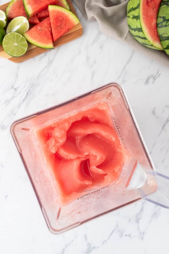 Top view of a blender filled with thick frozen watermelon margarita mixture
