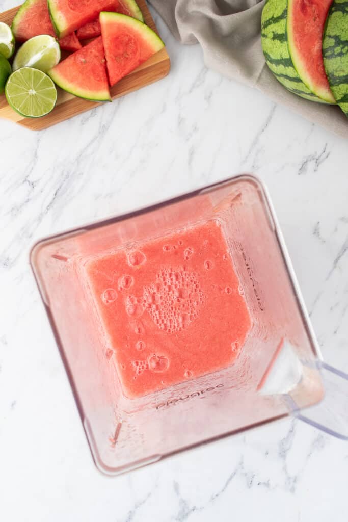 Blended watermelon margarita mixture in a blender, ready to pour