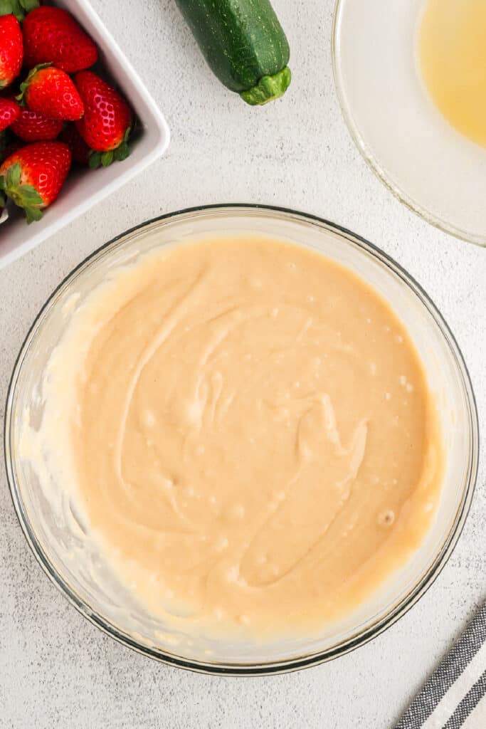 Fully mixed strawberry zucchini bread batter in a bowl, ready for add-ins