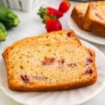 closeup of two slices of strawberry zucchini bread on plate