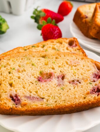 closeup of two slices of strawberry zucchini bread on plate