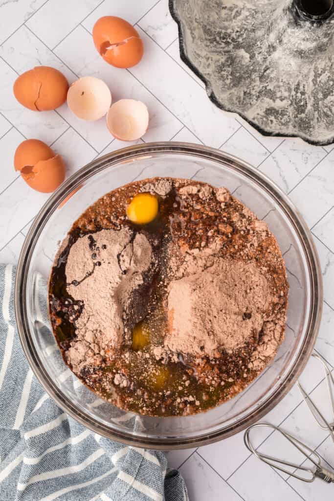 Ingredients for Kahlua cake combined in a glass mixing bowl, ready to be mixed.
