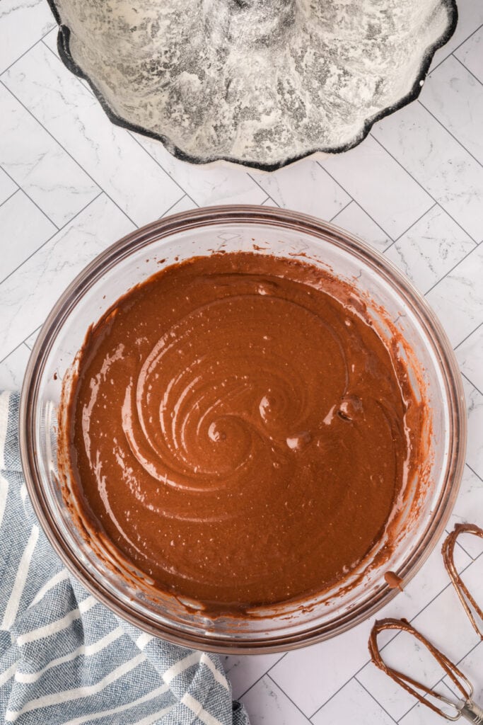 Smooth chocolate cake batter mixed and ready to pour into the Bundt pan.