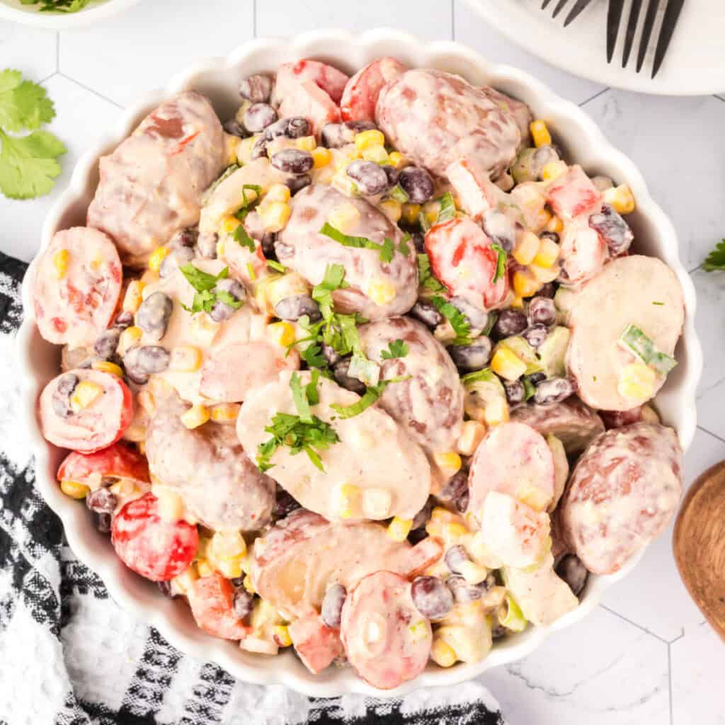 Overhead square image of Southwest Potato Salad served in a white dish, perfect for Pinterest.