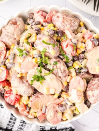 Overhead square image of Southwest Potato Salad served in a white dish, perfect for Pinterest.