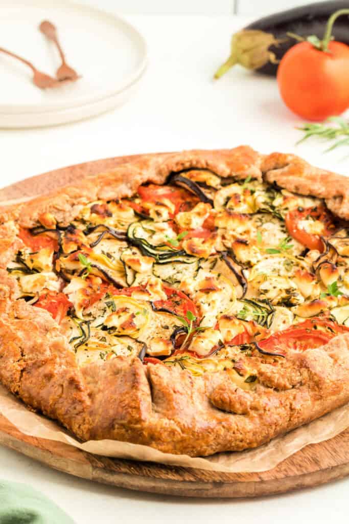 Close-up of the baked galette showing flaky crust and colorful roasted vegetable filling.