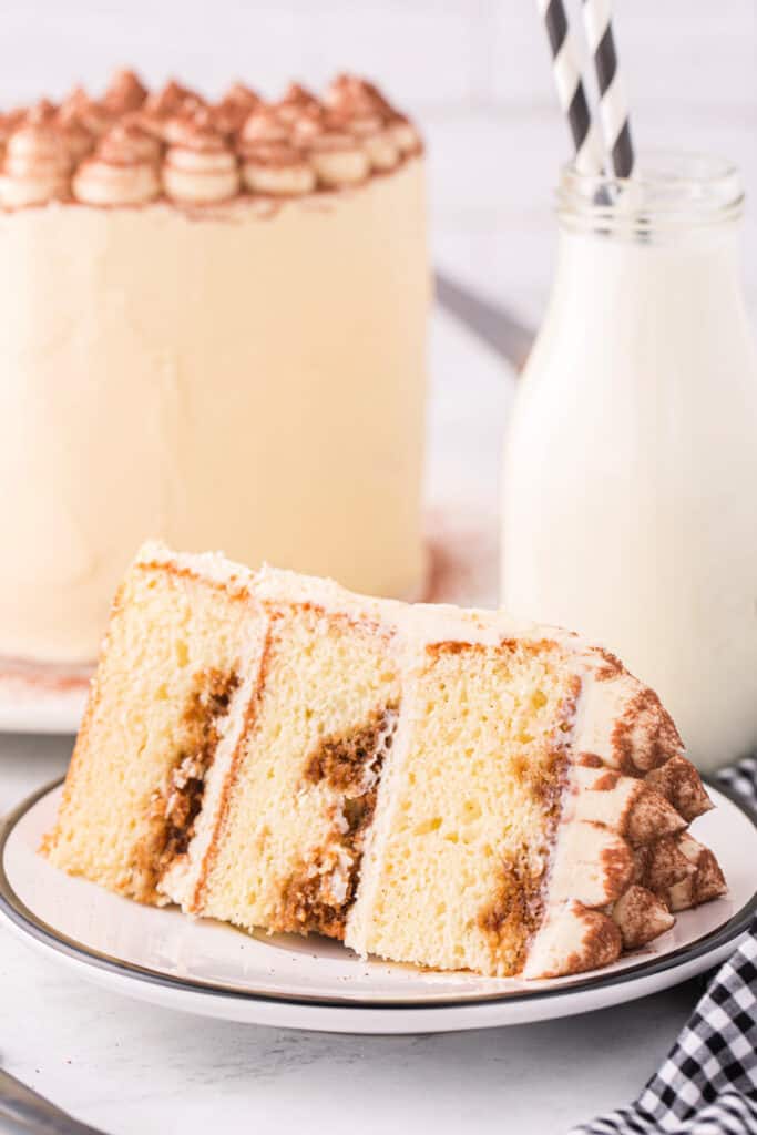 Slice of tiramisu cake served on a plate, perfect example of what is in tiramisu cake.