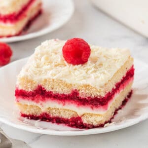 Square image of tiramisu slice topped with a fresh raspberry, perfect for social sharing
