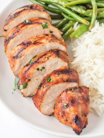 Square image of grilled balsamic chicken breast with white rice and green beans