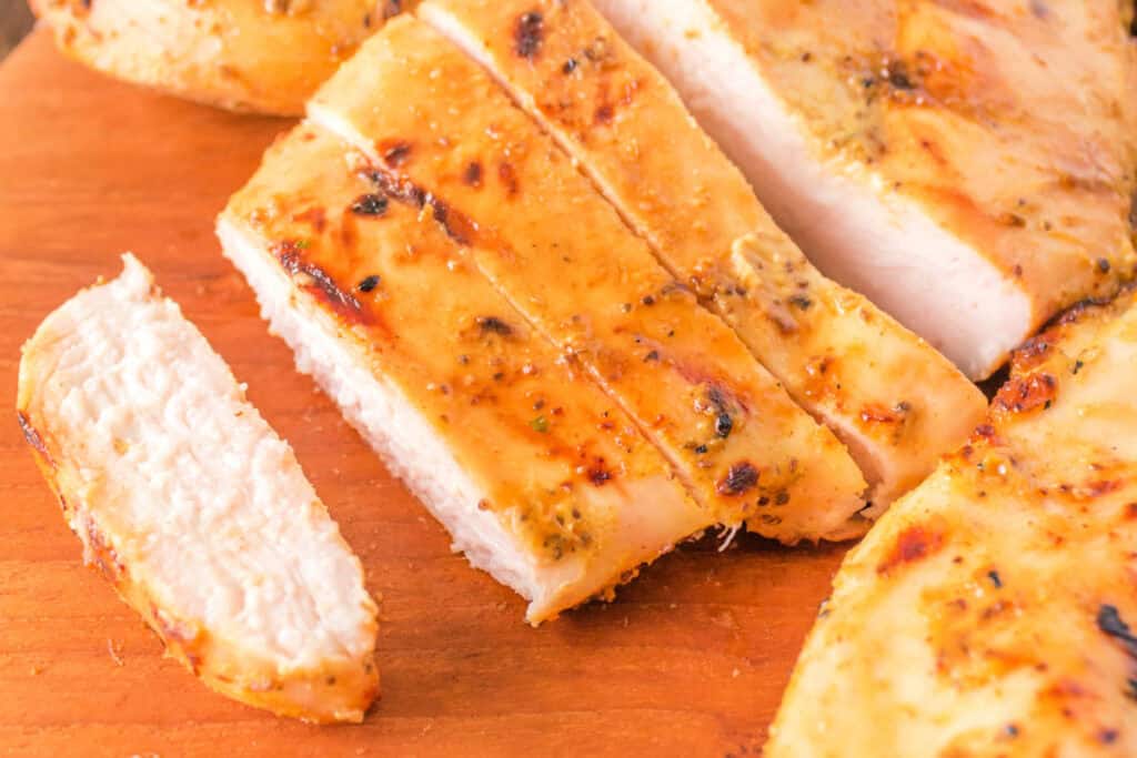 Sliced grilled honey mustard chicken breast showing juicy interior