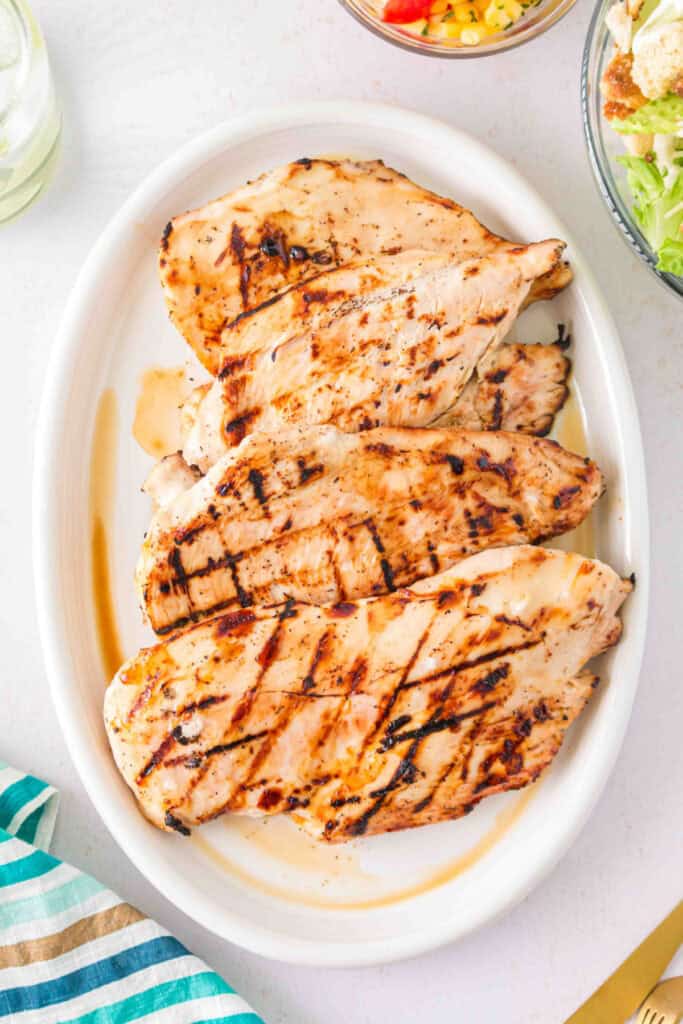 Overhead shot of grilled Margarita chicken served with salad and corn salsa