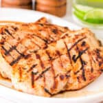 Square close-up of juicy grilled Margarita chicken breasts with lime drink