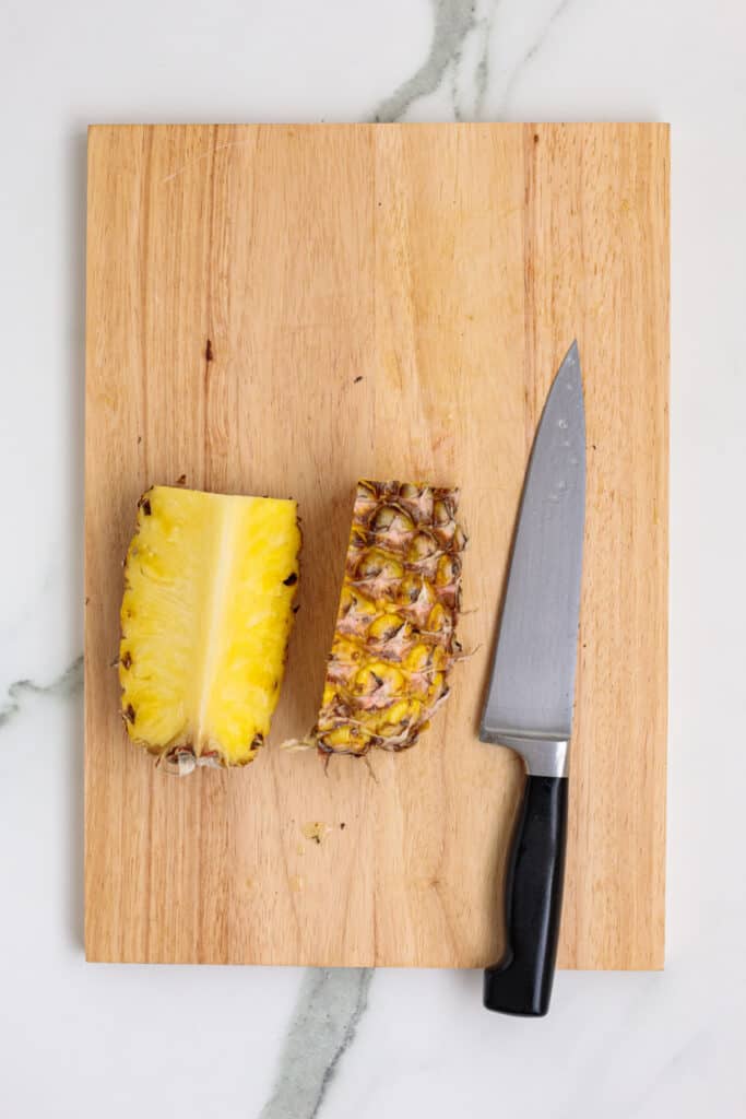 Pineapple cut into quarters, but showing 2 sections