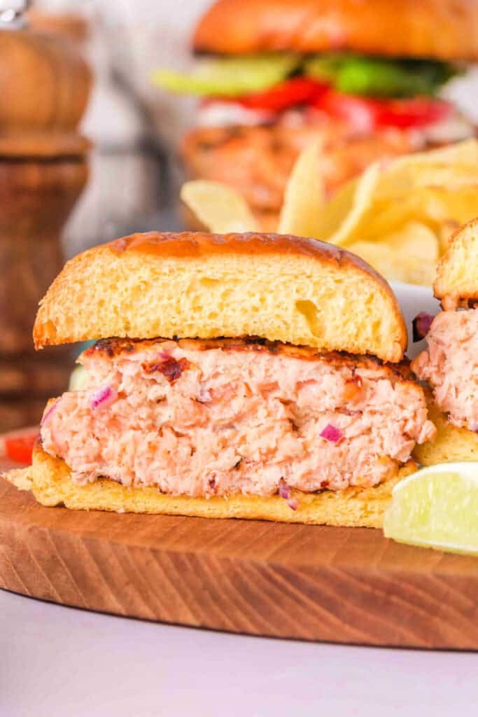 Cross-section of a grilled salmon burger showing moist, flaky inside
