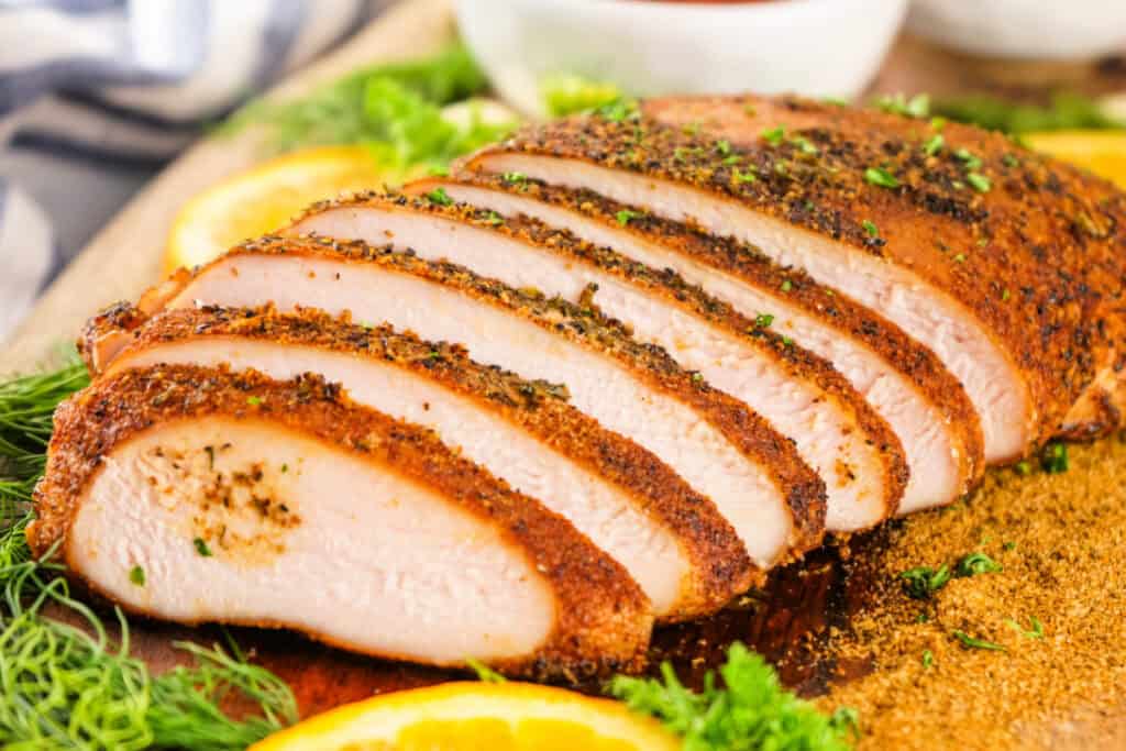 Close-up of sliced smoked Cajun turkey breast with a seasoned crust and juicy interior