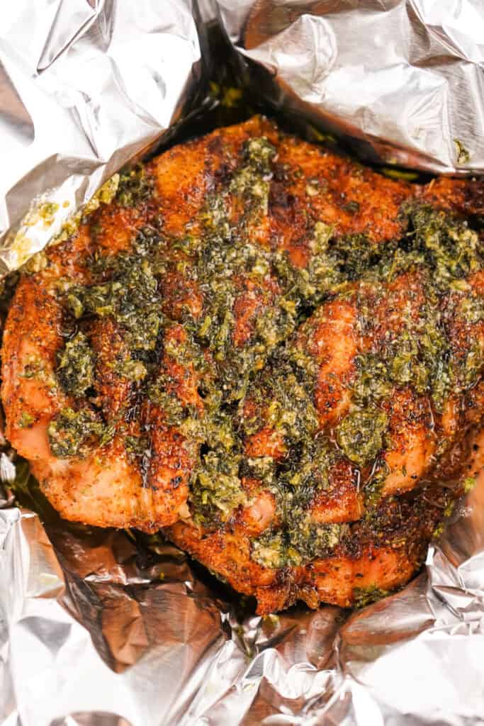 Smoked turkey breast topped with melted herb butter and fresh herbs before being wrapped in foil