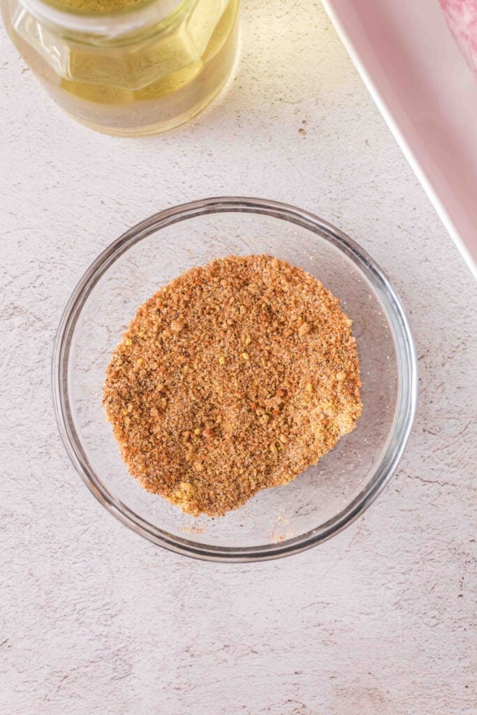 Seasoning mix fully blended in a glass bowl ready for rubbing on the pork
