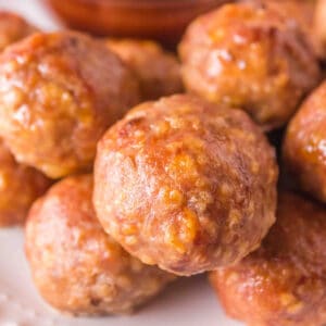 Square-cropped close-up of smoked turkey meatballs served with BBQ sauce.