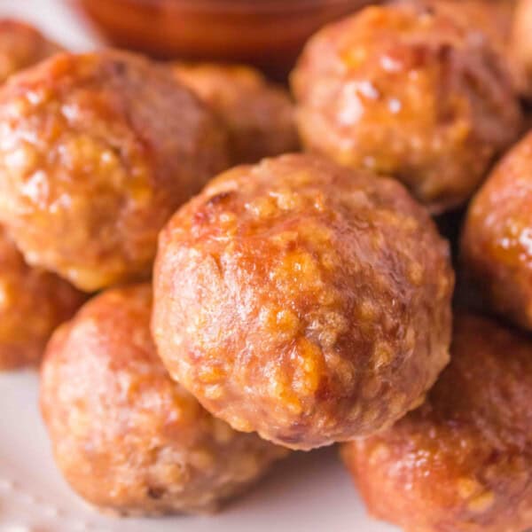 Square-cropped close-up of smoked turkey meatballs served with BBQ sauce.