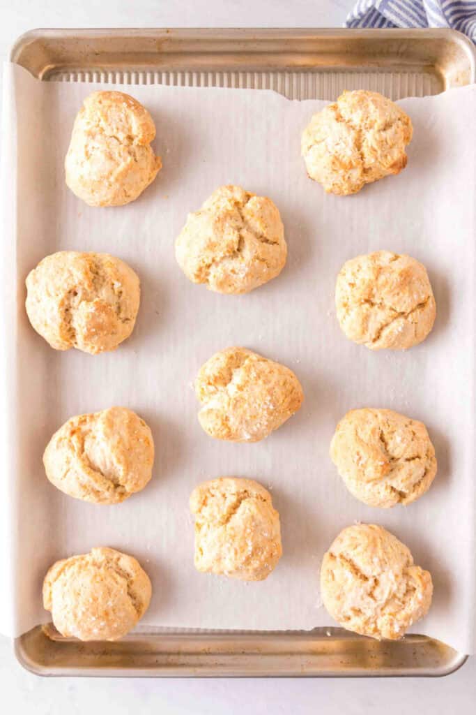 	Freshly baked golden scones cooling on a parchment-lined baking sheet