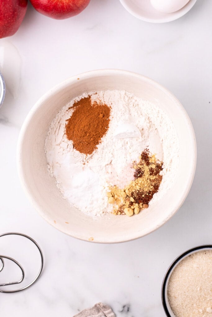 Dry ingredients including flour and spices grouped in a mixing bowl