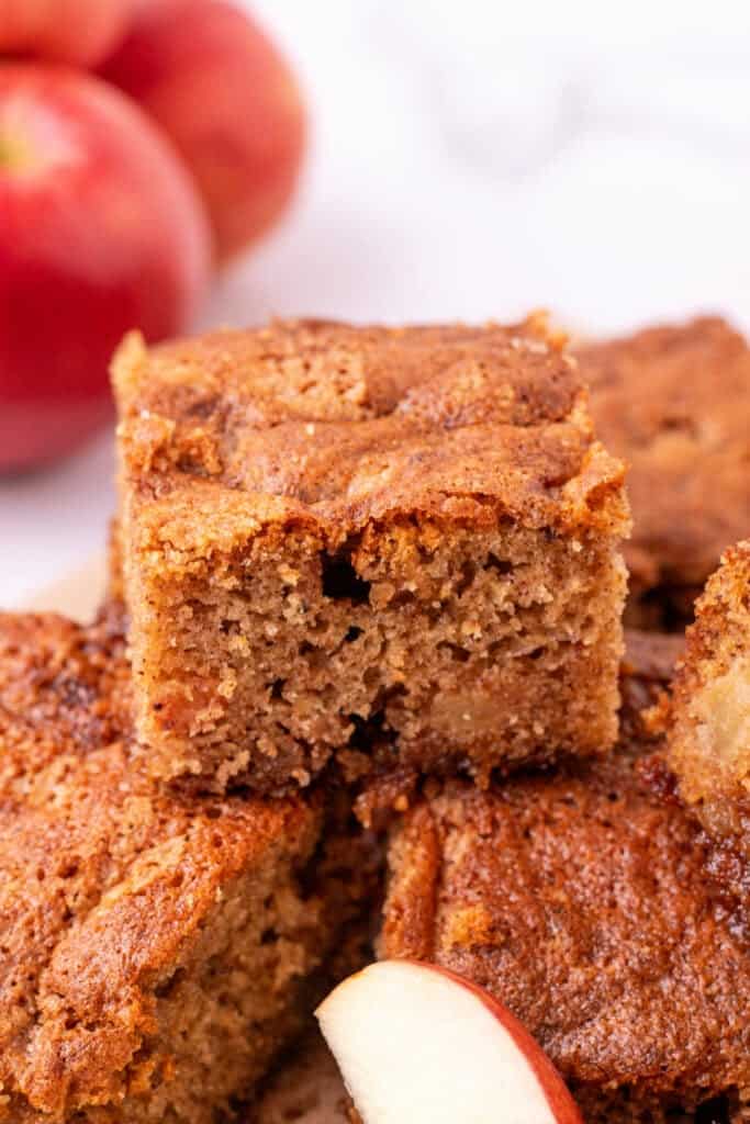 Close-up of sliced apple spice cake showing soft crumb and golden crust