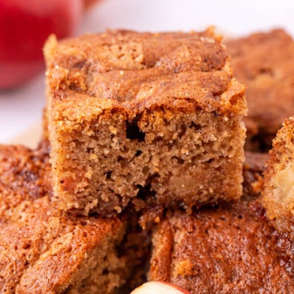 Square-cropped close-up of apple spice snack cake showing texture and cinnamon top