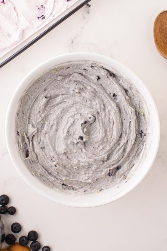 Blueberry pudding layer fully mixed with whipped topping, ready to spread