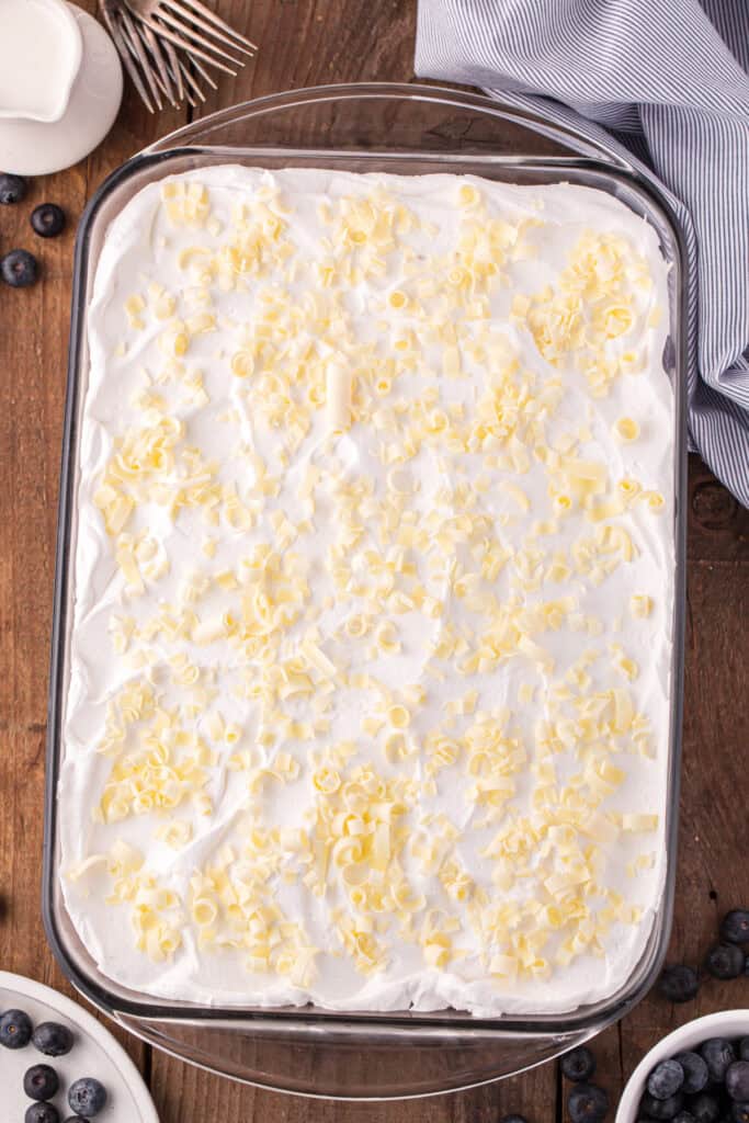 Final whipped topping layer with white chocolate curls in glass dish