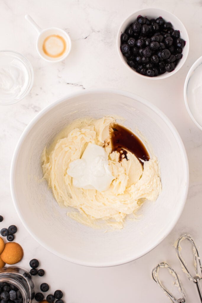 	Cream cheese mixture with vanilla and greek yogurt added, mixing in progress