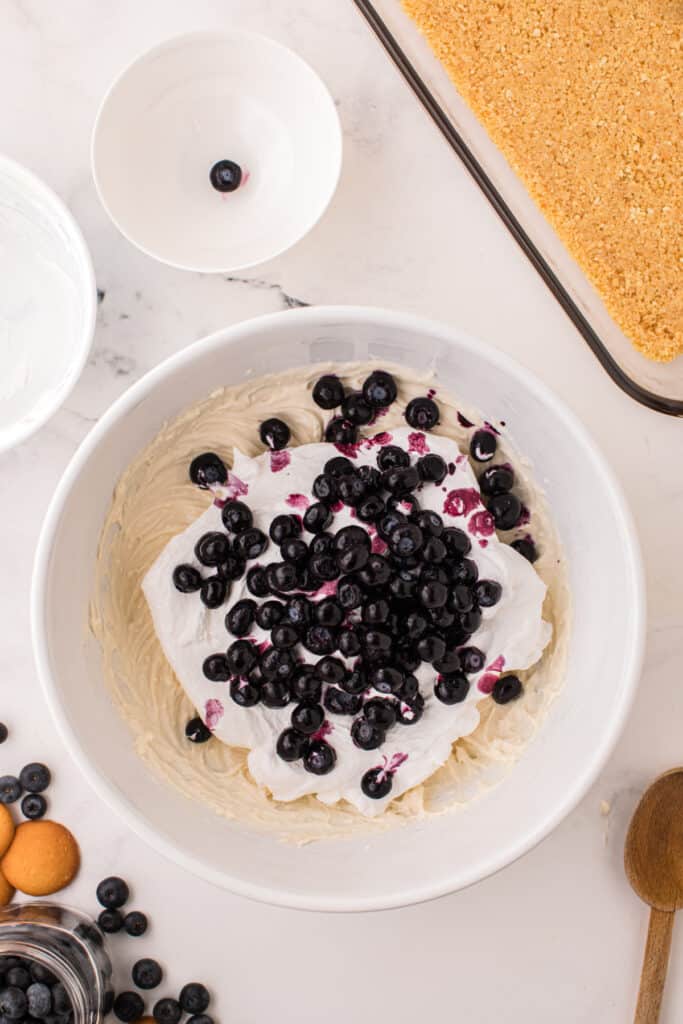 Frozen blueberries and whipped topping added to cheesecake mixture