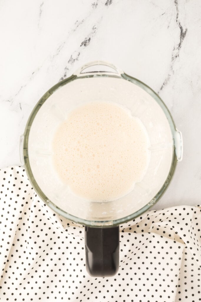 Blended Dirty Banana Cocktail mixture inside a blender, smooth and frothy