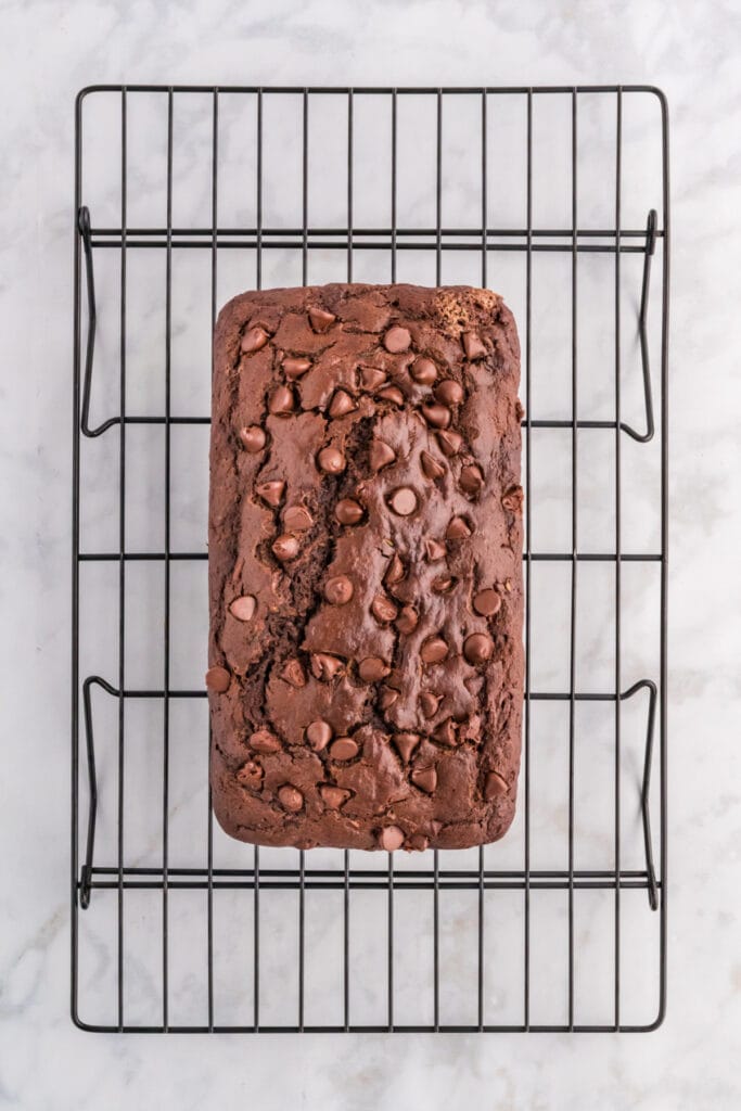 Chocolate zucchini bread loaf cooling on a wire rack.