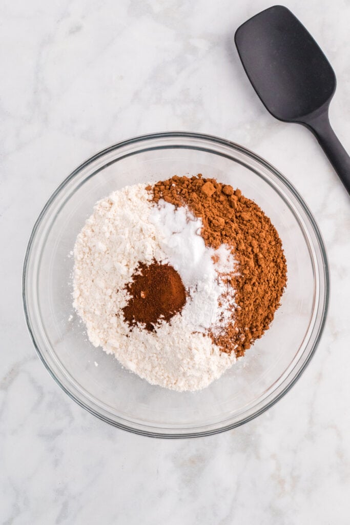 Mixing bowl with flour, cocoa powder, espresso powder, baking soda, baking powder, and salt.