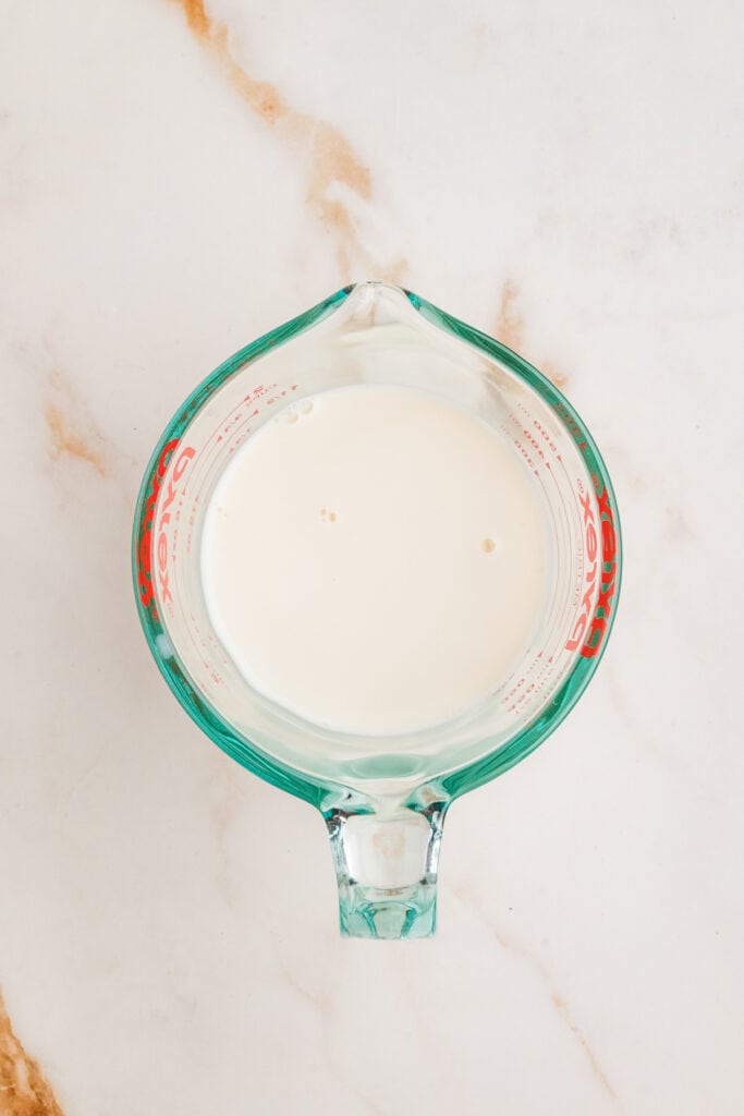Cold milk measured in a clear Pyrex glass measuring cup