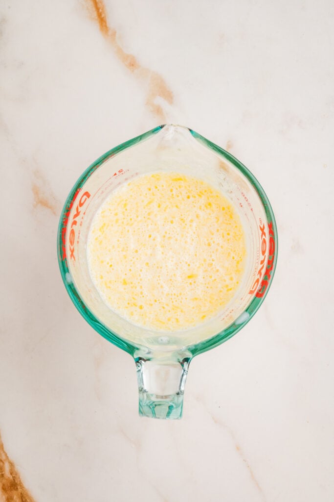 Wet ingredients fully whisked with visible bubbles and golden color