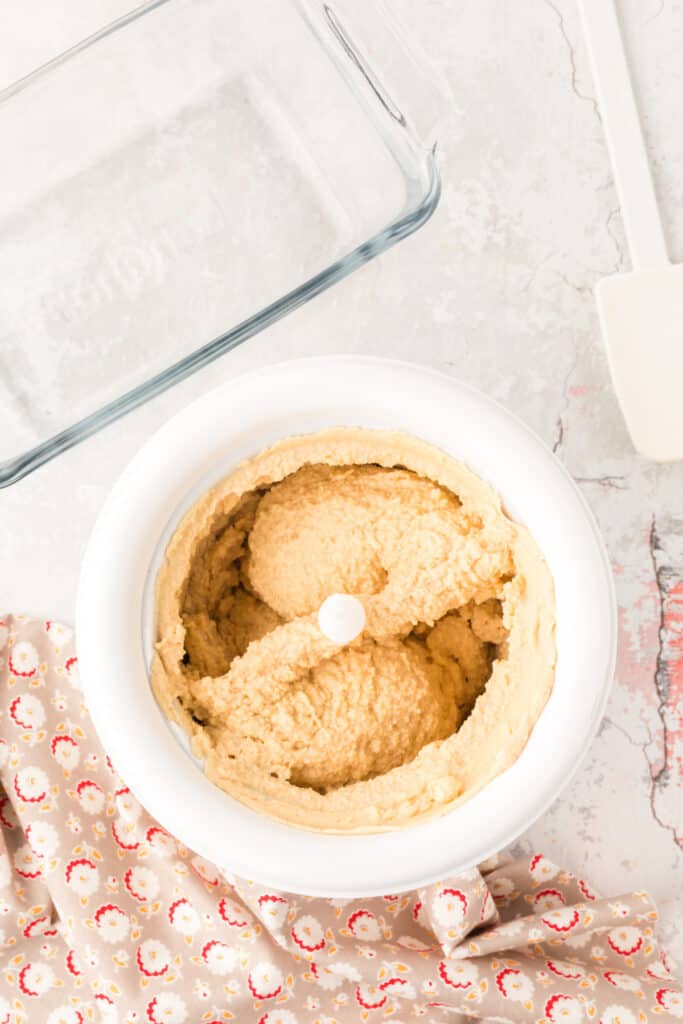 Churned peanut butter ice cream in an ice cream maker, ready to transfer.
