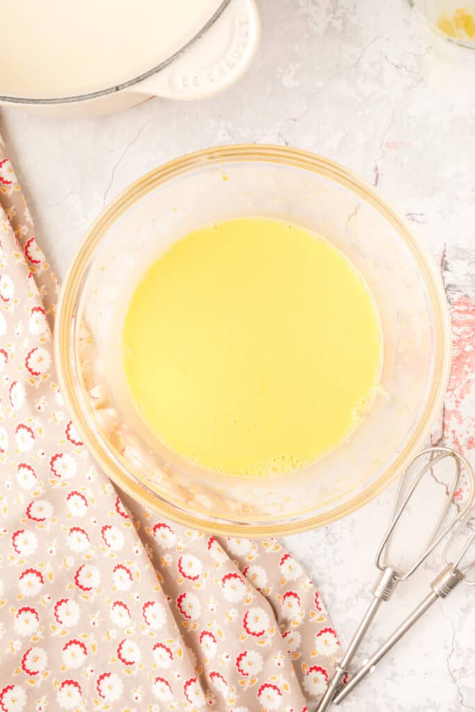 Final egg mixture in a clear bowl after tempering, ready to go back into the saucepan.
