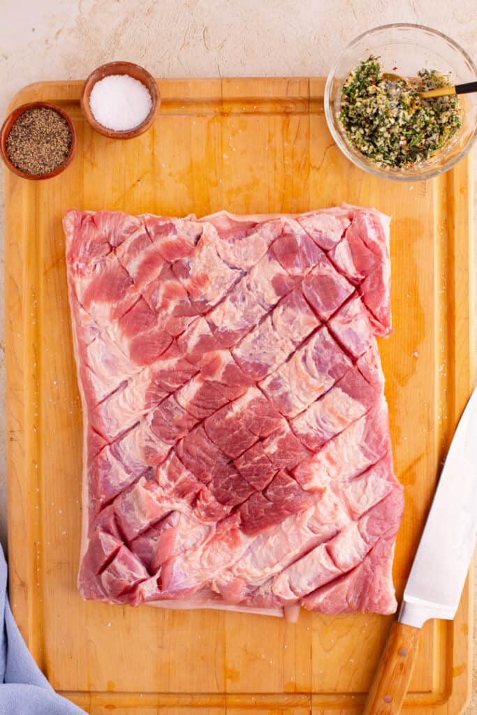 Pork belly scored in a crosshatch pattern, ready for seasoning