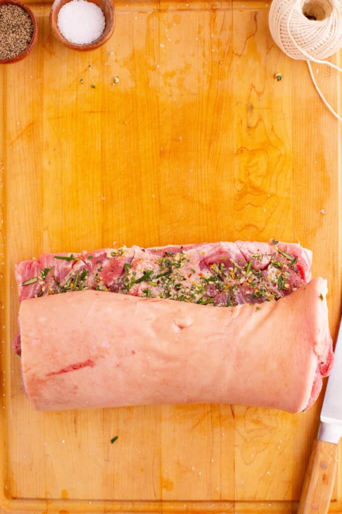 Pork belly rolled tightly with the filling inside, seam-side down