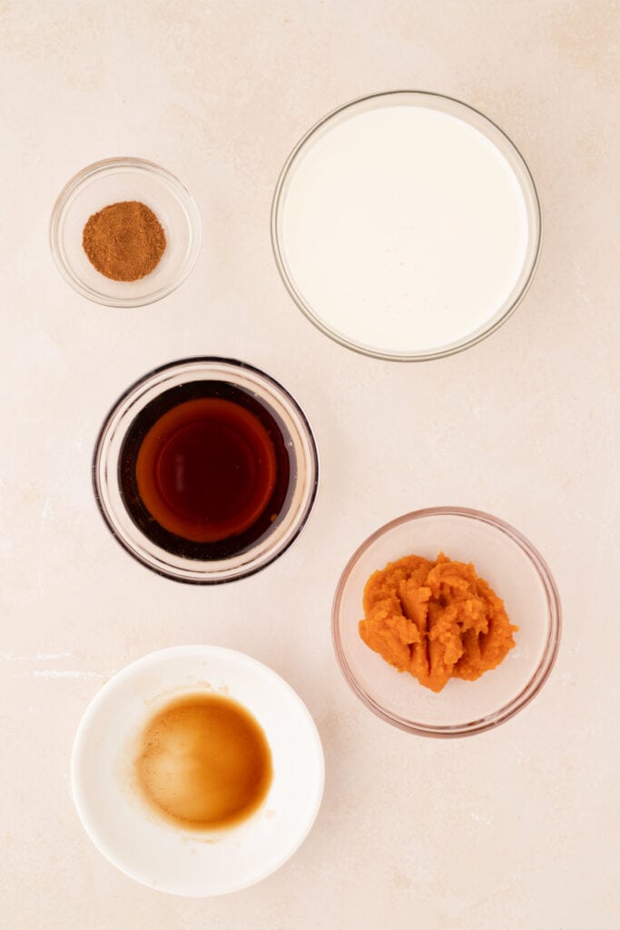 Overhead shot of individual ingredients in bowls for pumpkin spice creamer
