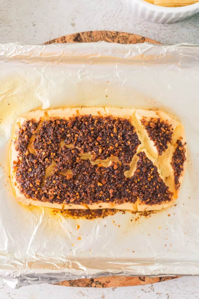 Smoked cream cheese fully cooked with a crispy top layer on foil