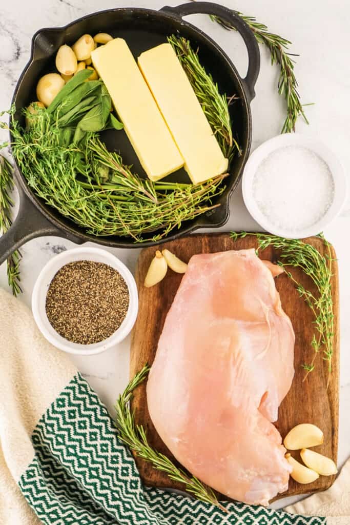 Ingredients for smoked garlic herb turkey breast, including butter, herbs, and garlic