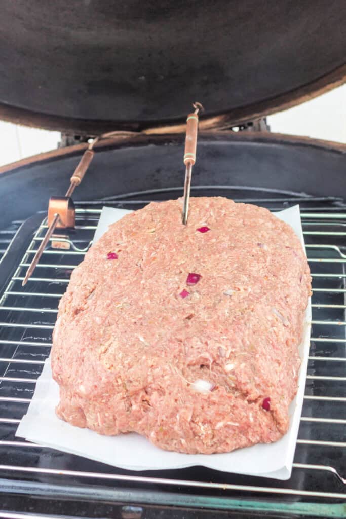 Meatloaf placed in the smoker with temperature probes inserted