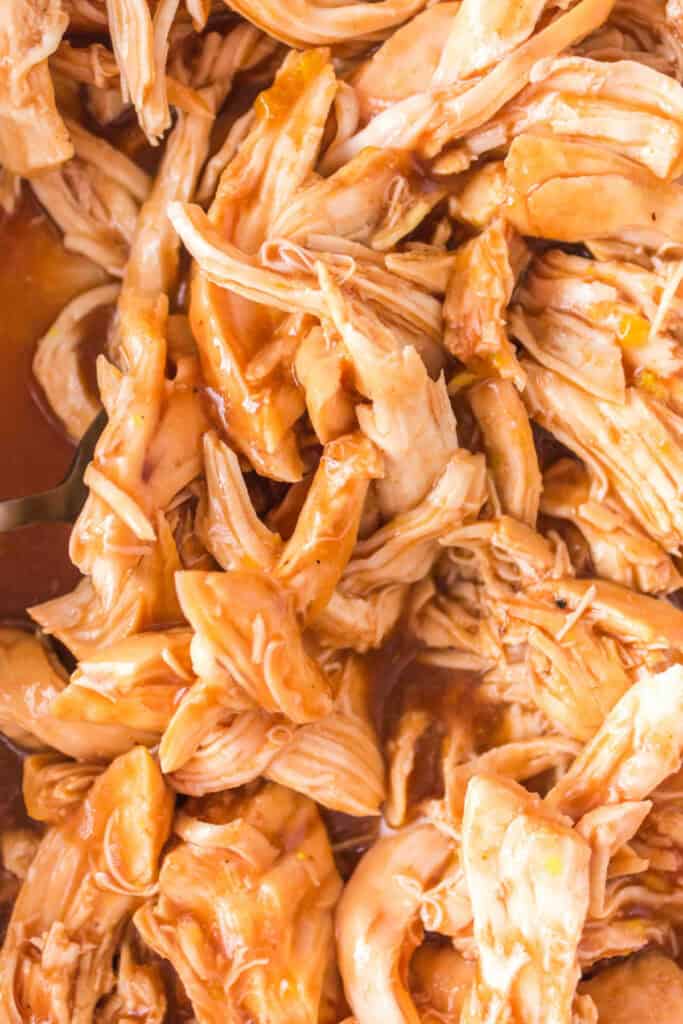 Close-up of shredded BBQ chicken mixed with sauce.