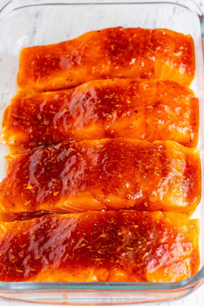 Salmon fillets coated in firecracker marinade, ready to be baked.