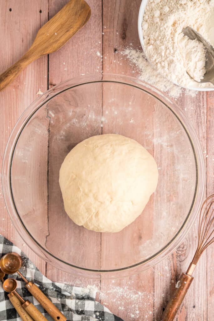 Smooth, kneaded dough formed into a ball and placed back in the bowl to rise.