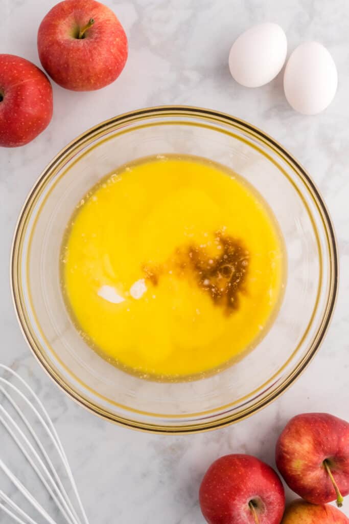 Mixing bowl with melted butter and vanilla extract, ready to be whisked with other wet ingredients.