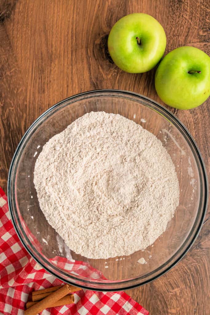 Dry ingredients whisked together in a large mixing bowl for apple fritter bread.