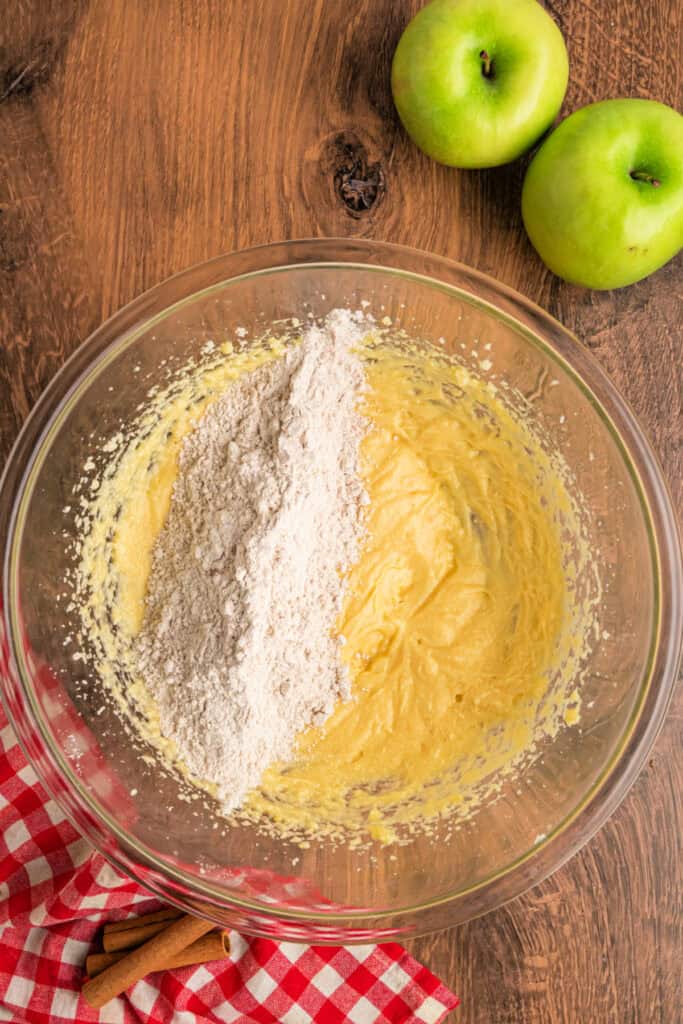 Mixing bowl with flour mixture being added into the wet ingredients.